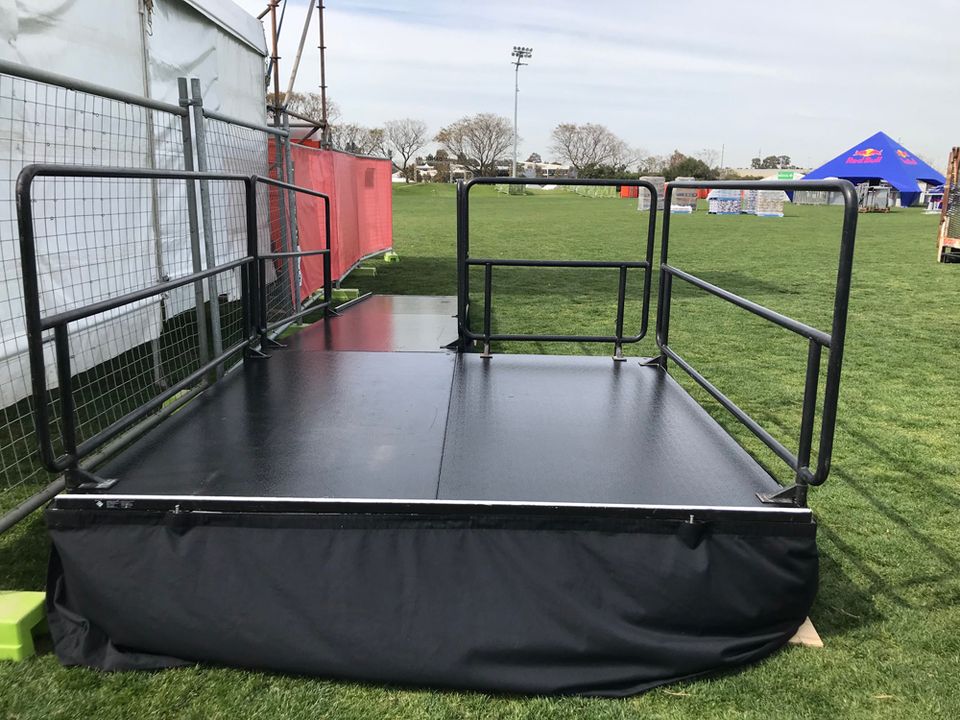 Raised platform with handrails on grass