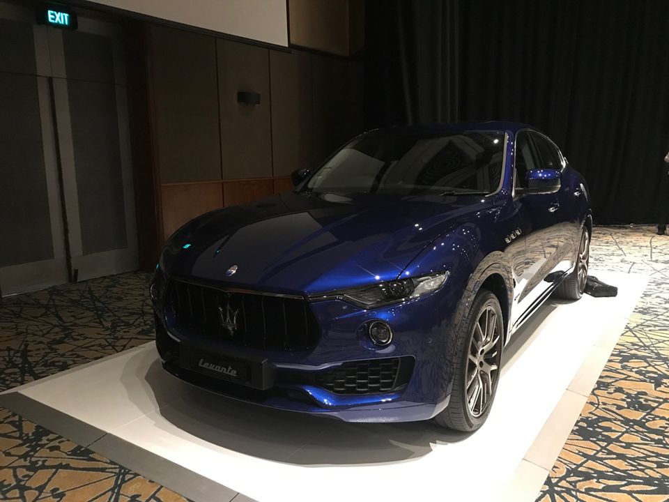 SUV displayed on a white low plinth in a venue