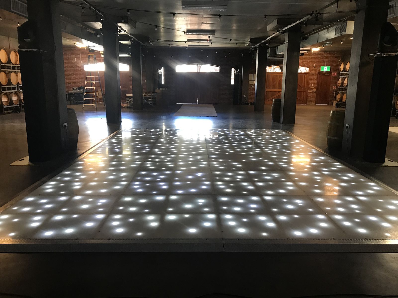 LED starlight floor glowing in a dark warehouse-style venue