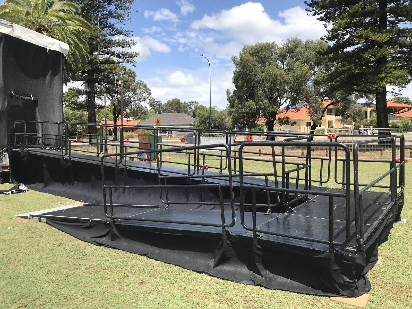 Outdoor stage with handrails set up in a park