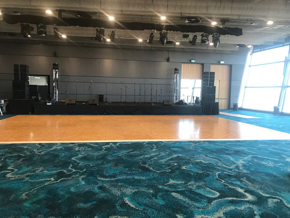 Parquetry dance floor in a function room in front of a stage