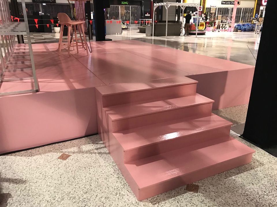 Pink-finished stage with wide steps in a shopping centre
