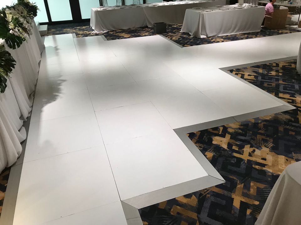 White multi-level stage and runway in a carpeted function room